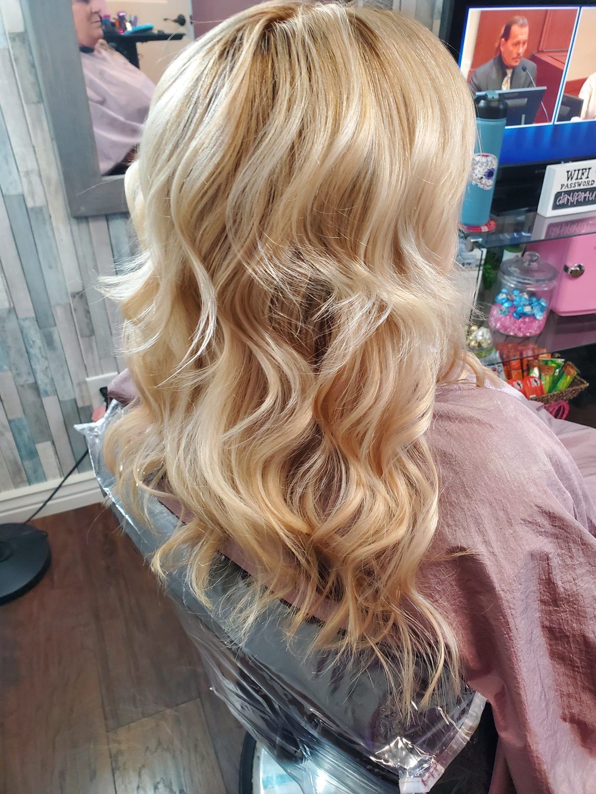 Bright blonde hair in soft, voluminous waves, shown from the side.
