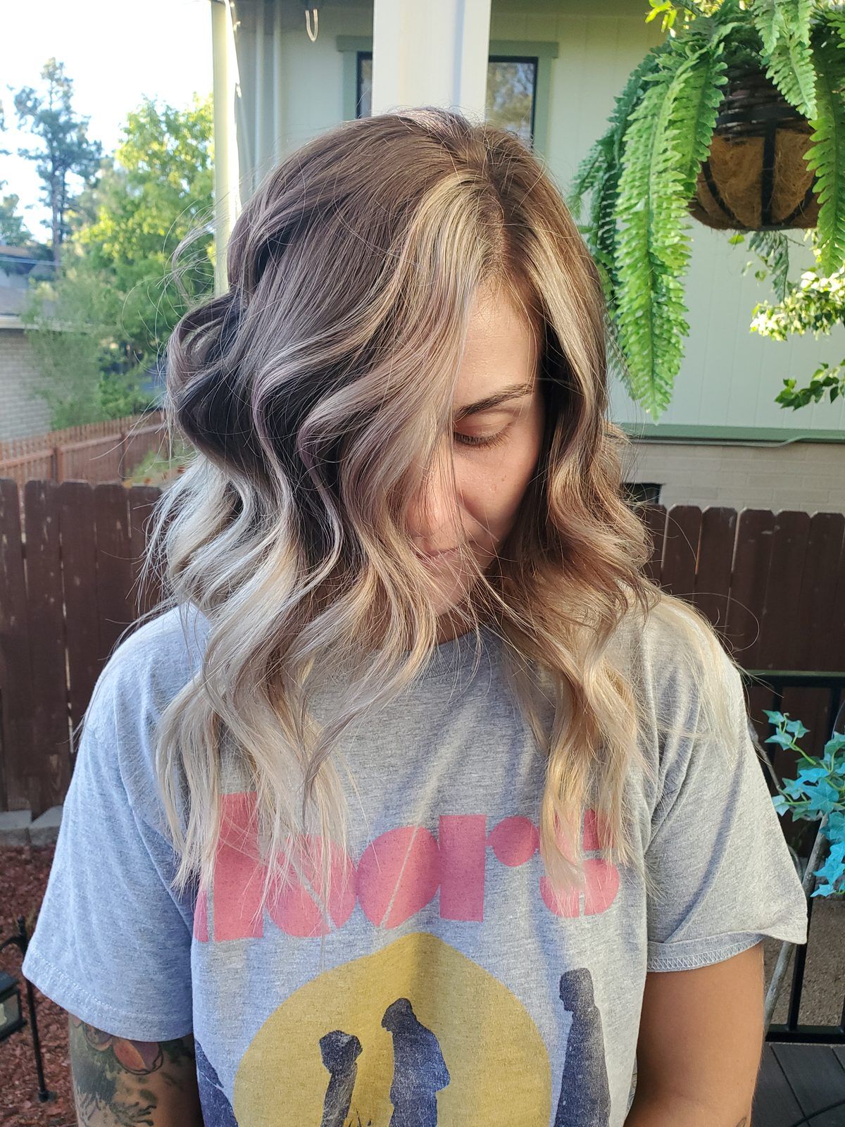 Shoulder-length balayage, dark roots blending to soft blonde ends in tousled waves.