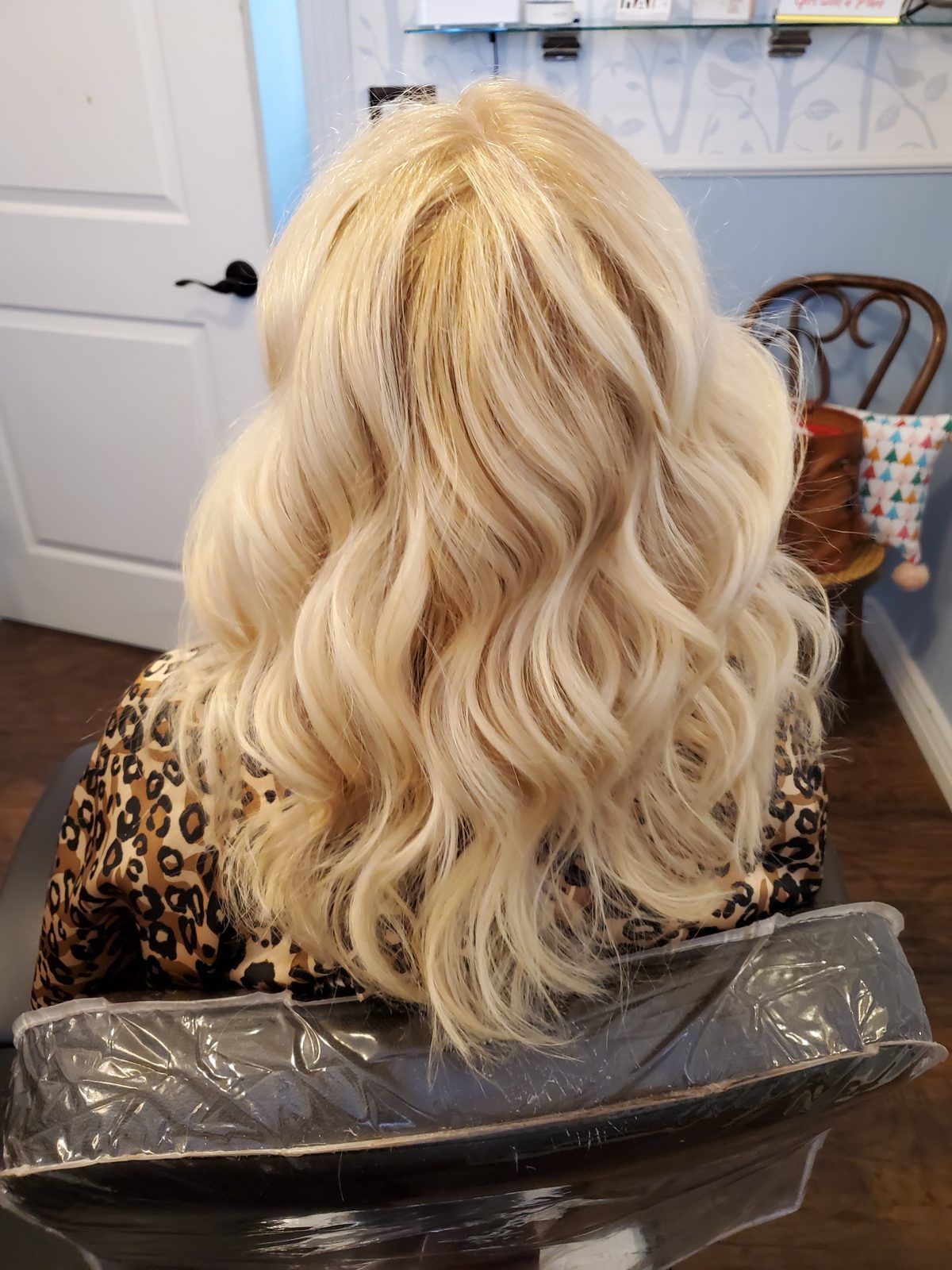Bright golden-blonde voluminous waves, shown from behind.