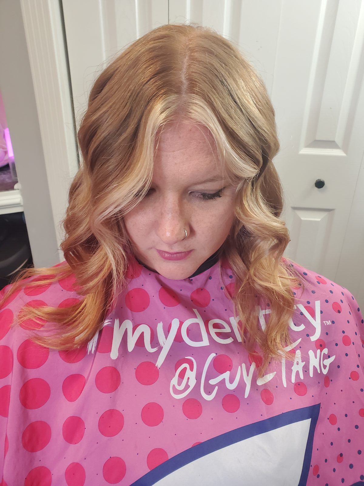 Warm strawberry-blonde waves with a lighter money-piece around the face, front view.