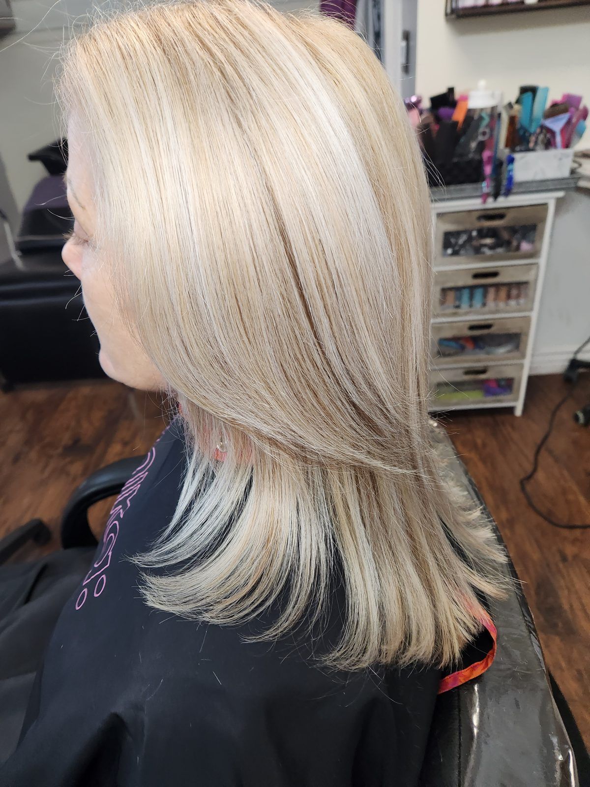 Bright icy-blonde hair, sleek with softly flipped ends, shown from the side.