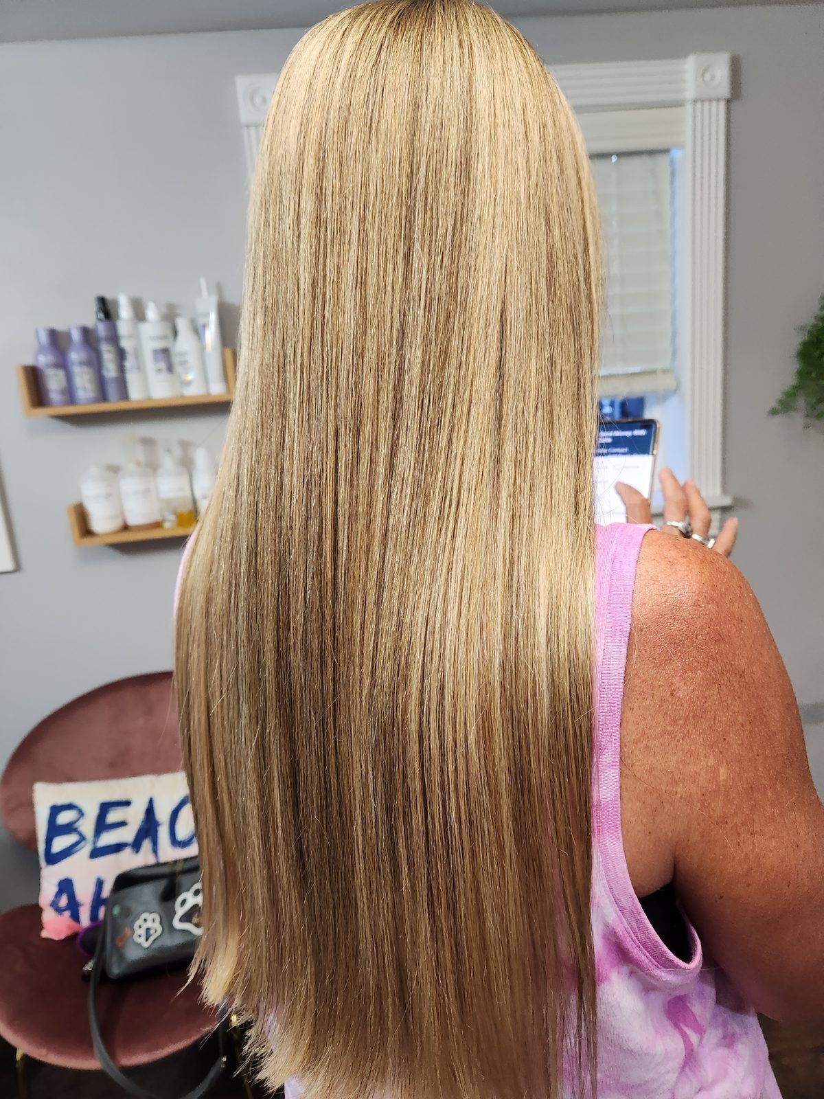 Long, sleek golden-blonde hair, shown from behind.