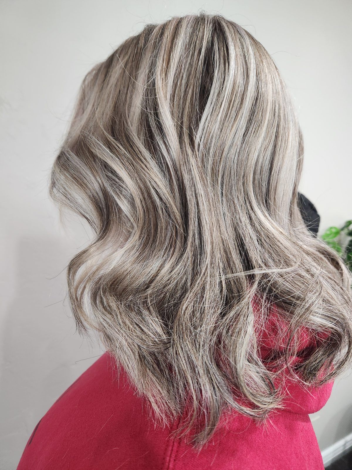 High-contrast ash-blonde and silver waves with darker ribbons, shown from the side.