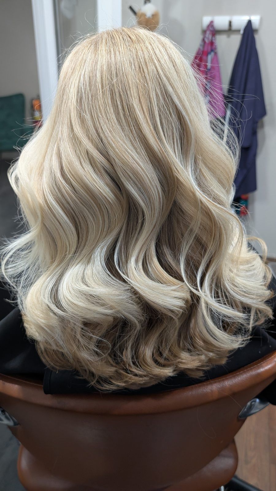 Creamy icy-blonde glamour waves, shown from behind.