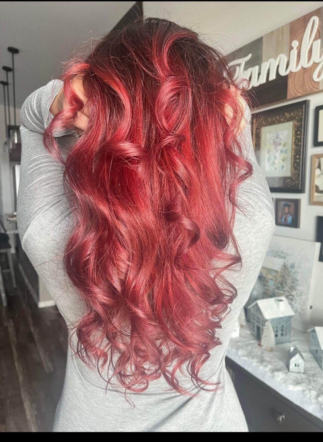 Vibrant red voluminous curls, shown from behind.